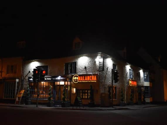 A view of the signs at night at the Dunchurch crossroads.