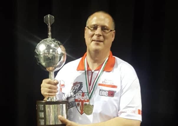Nigel Heydon shows off the Europe Cup after England's success in Budapest.