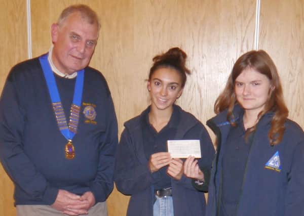 Warwick Lions President John Tunney presenting a cheque to Mia Pannu and Rebecca Dimmock from the Warwick Ambulance Association.