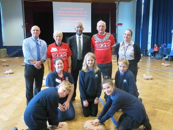 Kenilworth School's headteacher Hayden Abbott (back row, centre) with Year 8 pupils and CPR training volunteers including Kenilworth mayor Cllr Mike Hitchins (back row, second from right)