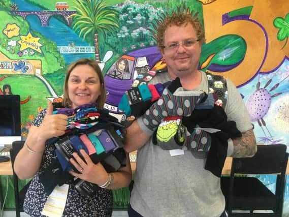 Hollie Hutchings and Gary Timlin (youth workers) with socks for the homeless