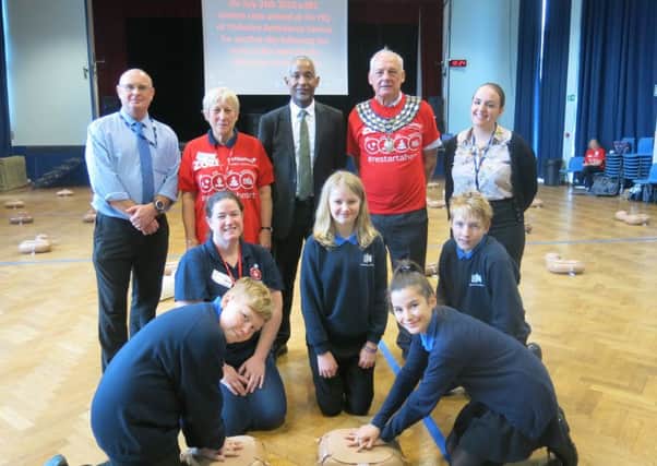 Kenilworth School's headteacher Hayden Abbott (back row, centre) with Year 8 pupils and CPR training volunteers including Kenilworth mayor Cllr Mike Hitchins (back row, second from right).