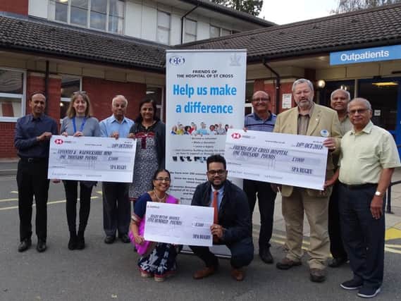Members of the Rugby Shree Prajapati handing over donations to representatives from Rugby Myton Hospice, the Friends of St Cross Hospital, and the Coventry and Warwickshire branch of Mind on Cromwell Road.