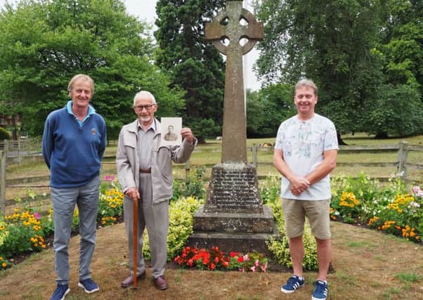 Dennis and Kevin Wormington with Andrew Hamilton at the Walton war memorial on which L-Cpl Arthur Wormington's name is engraved. Dennis holds a photo of Arthur taken during the First World War.
