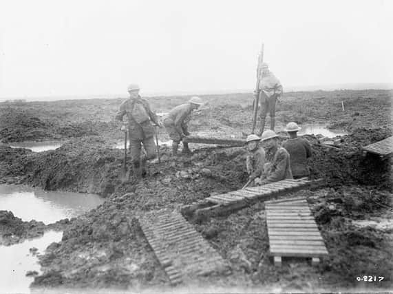 Soldiers laying trench mats, around the time of the Second Battle of Passchendaele.