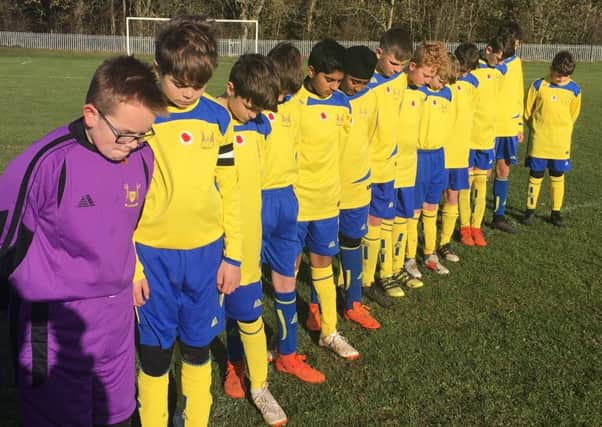 Brinklow Under 14s observing the minute's silence before their game on Remembrance Sunday