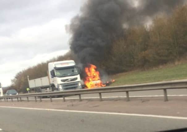 A vehicle on fire on the M40 near Gaydon. Photo: Rory Stringer NNL-181114-113706001