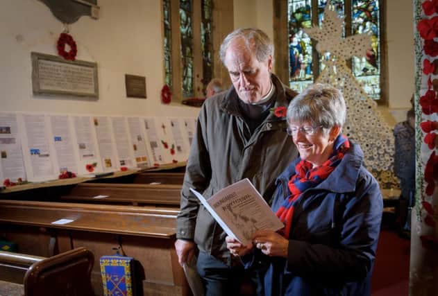 The Reverend Paul Wilkinson and Judith Edwards at the exhibition in St Botolphs Church, Newbold  which included her biographies of all 52 names on the war memorial which stands in  the churchyard