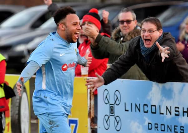 Scorer Lewis Rankin celebrates with fans at Pinchbeck on Saturday   PICTURES BY MARTIN PULLEY