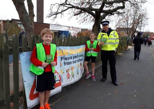 Pupils Eden Buswell and Sophia Penney, who are junior road safety officers at St Josephs Primary School,  on patrol  with PCSO Steven Sample of the Whitnash Safer Neighbourhood Team.