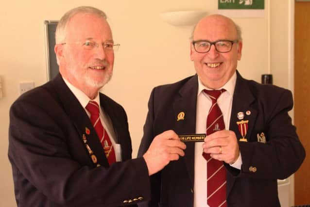 President Don Darby presents Secretary and Treasurer Michael Jackson (right) with Life Membership
