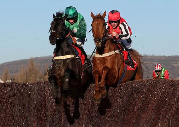 Sceau Royal ridden by Daryl Jacob, left, jumps the last with Simply Ned ridden by Brian Hughes on their way to victory in the Shloer Chase during day three of the November Meeting at Cheltenham Racecourse.