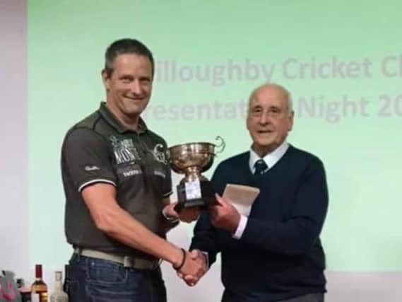 Senior Player of the Year Ashley Rayner receives his trophy from club president Eric Palmer