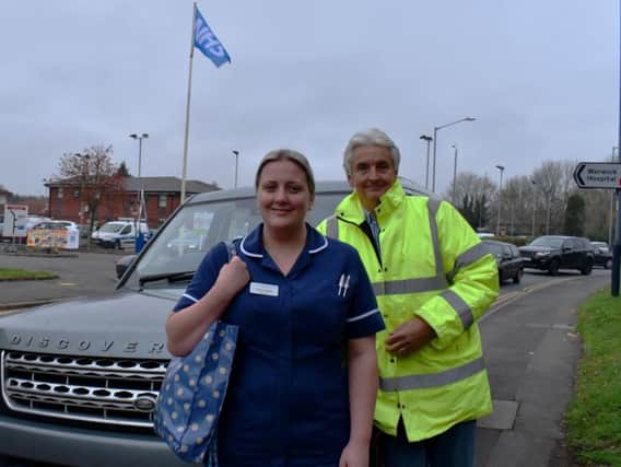 Graeme Wright (right) with clinical sister Sarah Rawlings outside Warwick Hospital with a 4x4