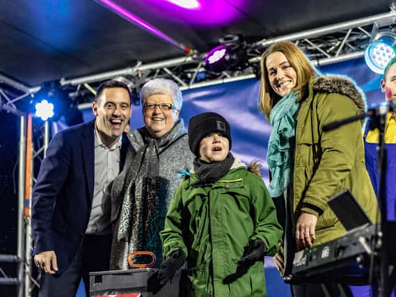 From left: Cllr Richard Hales with June Clifford, Alfie Dingley and Hannah Deacon before turning on Warwick Road's lights. Photo: Richard Ward