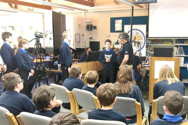 Pupils preparing to ask their questions with ARISS engineers maintaining the signal.