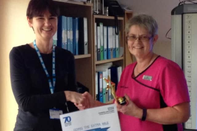 Paula Colin of Brookeside Surgery receives her award.