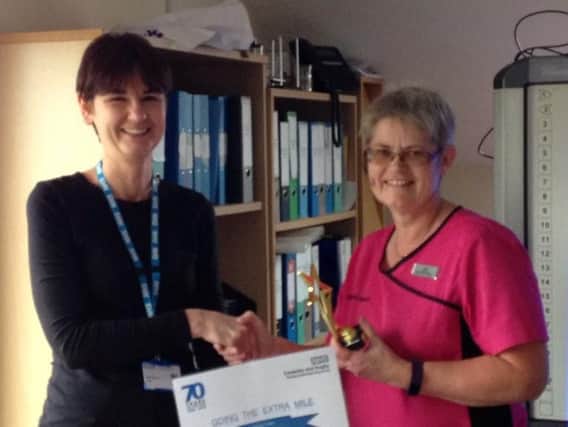 Paula Colin of Brookeside Surgery receives her award.