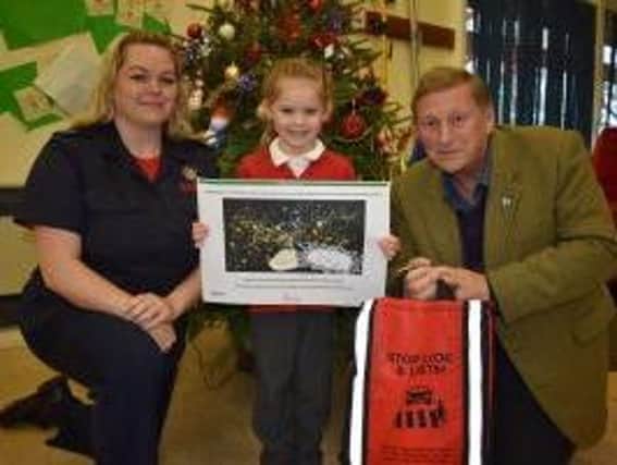 Indianna, Abbots Farm Infant School with Councillor Jerry Roodhouse and Gemma Childs from Warwickshire Fire and Rescue Service.