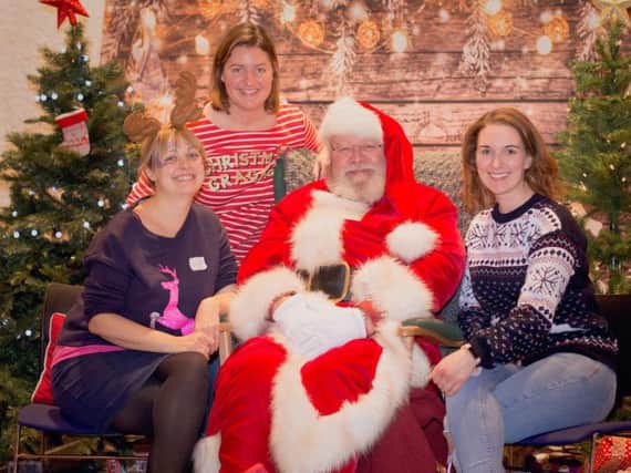 Left to right: Nicki Scott, Bailey Lamburn and Lucy Field with Father Christmas. Photo by Offspring Photography