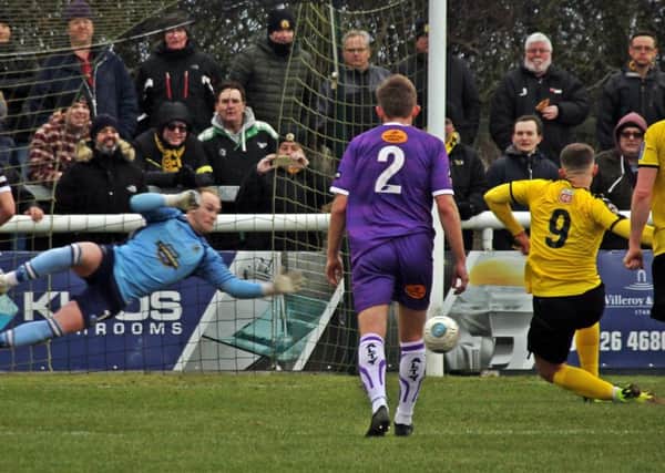 Colby Bishop's penalty beats Anthony Thompson despite the Altrincham keeper guessing the right way. Pictures: Sally Ellis