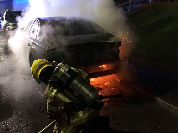 A firefighter used a hose reel to extinguish the burning Audi. Photo: Kenilworth Fire Station.