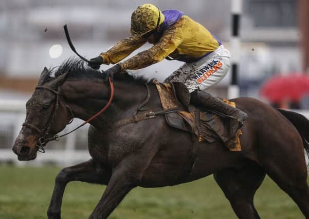 Jack Quinlan and Kalashnikov clear the last to win The Betfair Hurdle Race at Newbury.