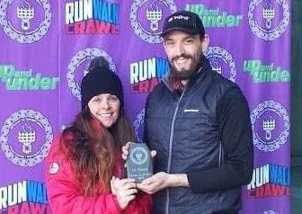 Mel Venables receives her trophy for winning the Brecon to Cardiff Ultra.