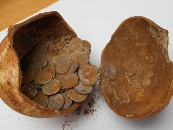 The coins in vessel they were discovered in. Photo by Warwickshire County Council.