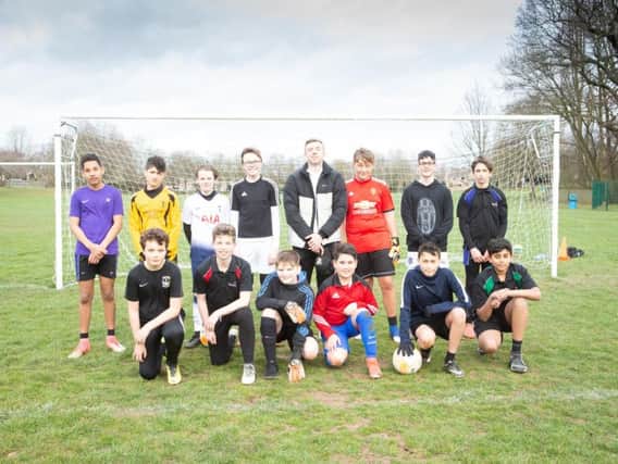 Jordan Shipley joined school footballers for a team shot