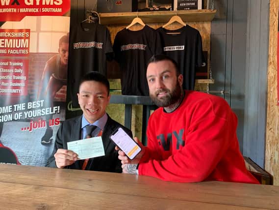 Zien Zhou with Jack Gibson, director of Fitness Worx and the cheque. Photo by Fitness Worx