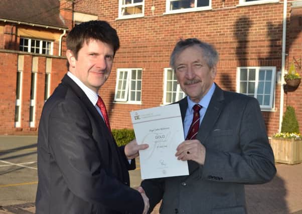 Nigel Robinson receives his DofE Gold Award from headmaster Dr Deneal Smith.