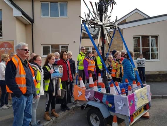 The cross of knives at Kenilworth Methodist Church and of the crowd who assembled to see the walkers depart. Photo submitted.