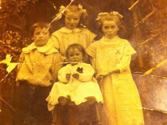 The Pickett children are pictured in front of their cottage in Church Terrace, Cubbington. The baby in the high chair is baby Iris, the boy on the left is William Pickett Jnr, known as 'Son,' and the girl at the back is Violet.