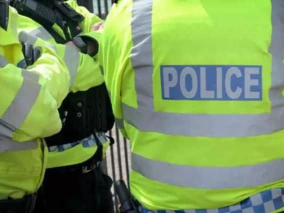 A man has been arrested on suspicion of assault after a woman was injured in a collision in Victoria Street in Warwick.