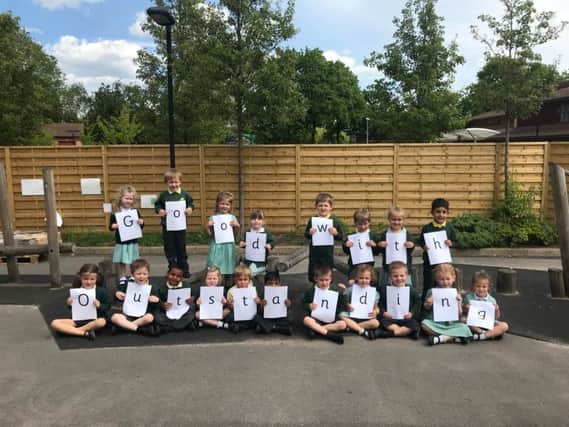 Pupils celebrate Woodloes Primary School's positive Ofsted report.