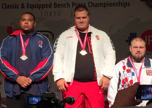 Joe Guest-Bourne. left, on the podium in Tokyo. Pictures submitted