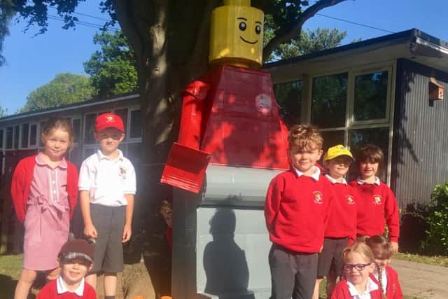 The school unveiled a giant scarecrow-like Lego man as its mascot scarecrow created by volunteers with the school's PTA
