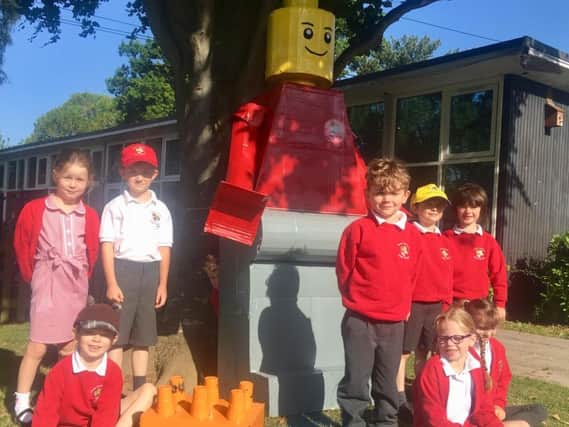 The school unveiled a giant scarecrow-like Lego man as its mascot scarecrow created by volunteers with the school's PTA