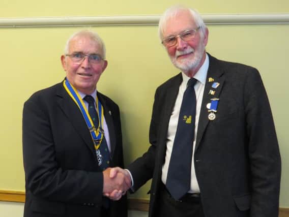 Outgoing President David Smith (right) wishes his successor President David Brain well. Photo submitted.