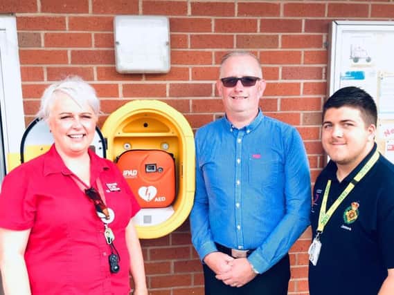 Ali Collett, her husband, Andy Collett and first responder James O'Neill, who used a defibrillator on Andy saving his life moments after CPR had already been done by Ali