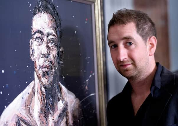 Artist Paul Oz with the portrait of Dick Turpin.