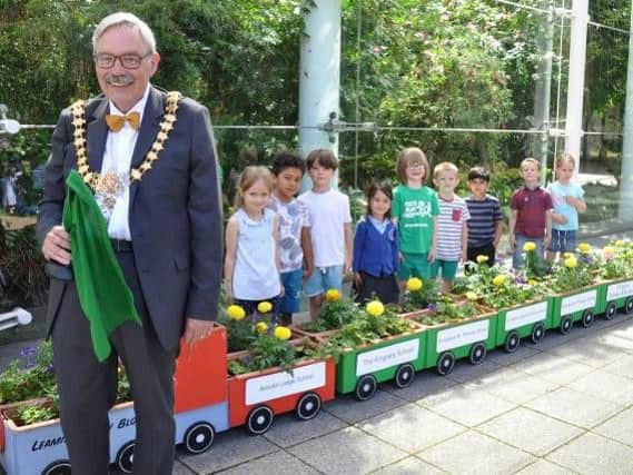 Leamington Mayor, Cllr Bill Gifford, launches the Leamington in Bloom Floral Train with some of the school children from Clapham Terrace Primary School, who grew the flowers.