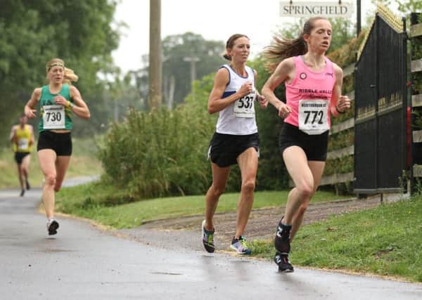 Kelly Edwards battles it out at the head of the field in the Northbrook 10k. Pictures: Tim Nunan