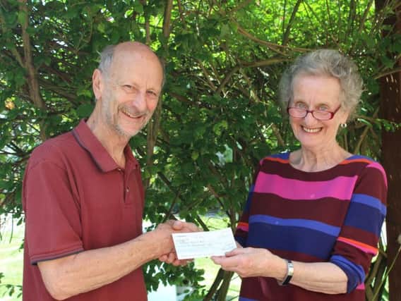 John Sheldon, director of Singing for Pleasure, handing over a cheque to Viv Morgan, chair of trustees at Northleigh House School. Photo submitted