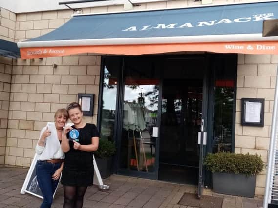 Manager Ania Juszkiewicz (right) holds the Refill sticker and Emma Owen, who also works at the Almanack.