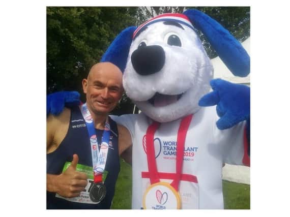 Simon Perkin with his silver medal and a mascot from the World Transplant Games. Photo supplied.