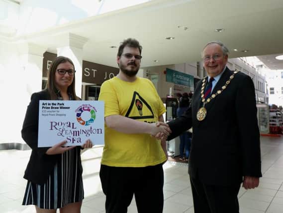 Sarah Jones, Royal Priors Shopping Centre Manager, James Webb, Art in the Park competition winner and Councillor George Illingworth, Chairman of Warwick District Council inside the Royal Priors Shopping Centre in Leamington. Photo submitted.