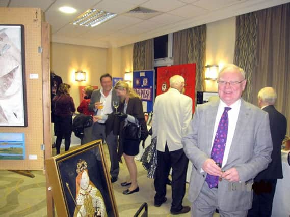 Visitors at a previous Kenilworth Rotary Club Art Exhibition and Peter Roberts, a member of the rotary club