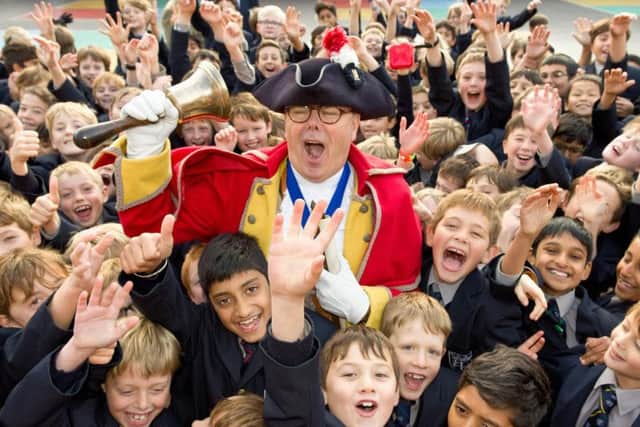Warwick Town Crier, Michael Reddy, with pupils at Warwick School. Photo supplied.